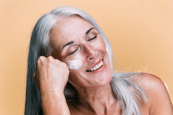 Image of a beautiful senior woman posing on a beauty photo session. Middle aged woman on a colored background. Concept about body positivity, self esteem and body acceptance - Foto, Bild