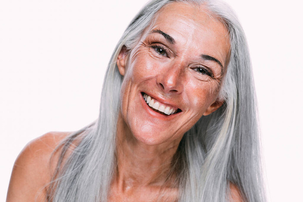 Image of a beautiful senior woman posing on a beauty photo session. Middle aged woman on a colored background. Concept about body positivity, self esteem and body acceptance - Fotoğraf, Görsel