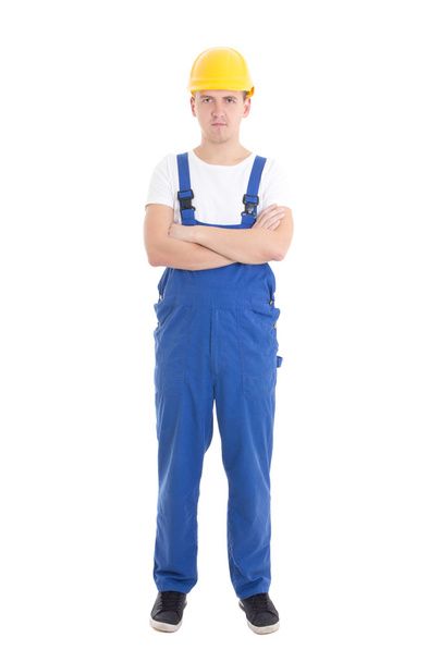 hombre guapo joven en uniforme azul builder aislado en blanco - Foto, Imagen