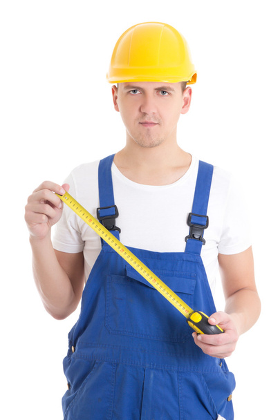 man bouwer in blauwe overall houden maatregel tape geïsoleerd op w - Foto, afbeelding