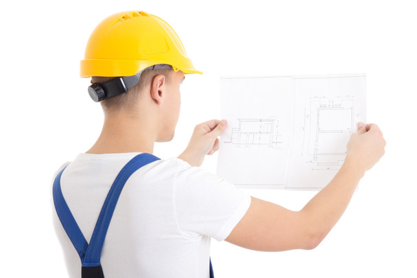 Man builder in blue uniform and helmet holding blueprint isolate - Photo, Image
