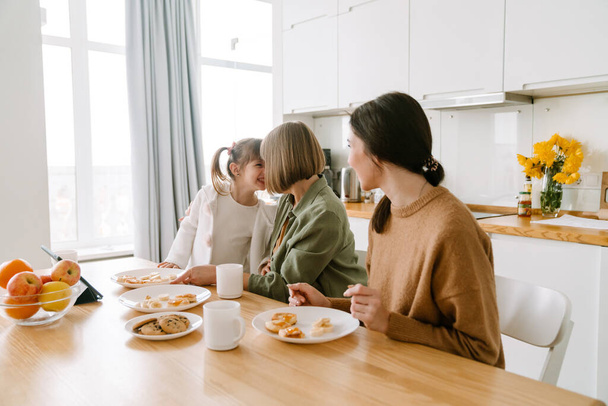 White family having breakfast while spending time together at home - Фото, изображение