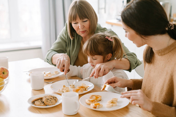 White family having breakfast while spending time together at home - Foto, afbeelding