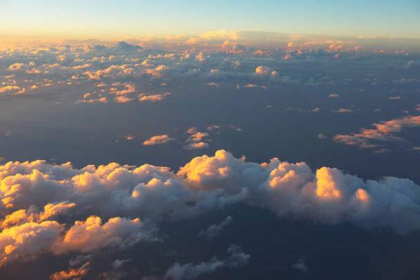 Evening clouds over the ocean . Clouds view from above in twilight - Photo, Image