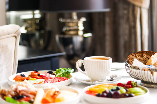 Luxury hotel and five star room service, various food platters, bread and coffee as in-room breakfast for travel and hospitality brand - Valokuva, kuva