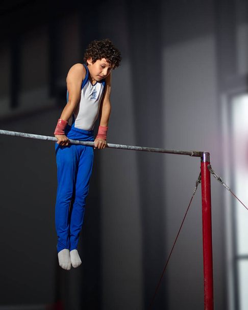 Queretaro, Queretaro, 11 18 22, young hispanic boy practicing aerobic gymnastics in gym during the summer - Fotoğraf, Görsel