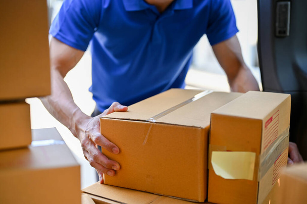 Close up view of delivery man organizing parcels before giving it to customer. parcel delivery service concept - Fotografie, Obrázek
