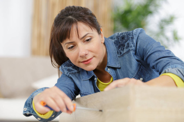 woman moving into new apartment house assembling - Photo, image
