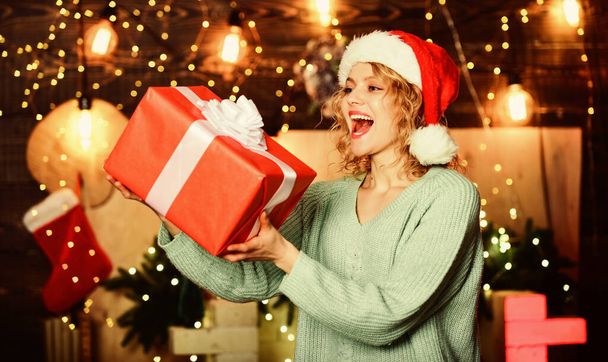 Charity and kindness. Woman hold gift box christmas decorations background. Christmas is by far most awaited for holiday of year. Girl with gift present. Be generous. Things to do before christmas. - Foto, afbeelding