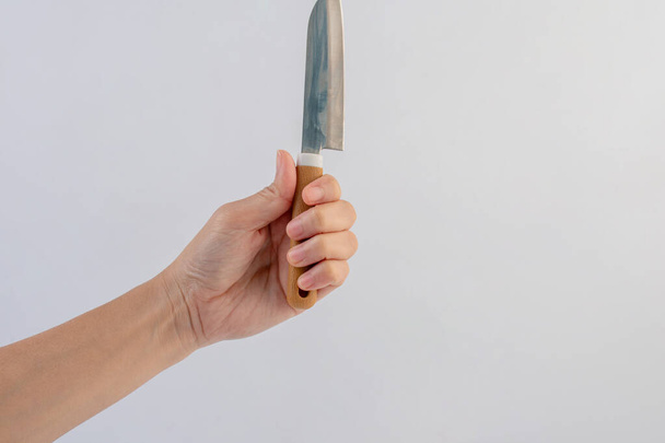 Hand and utility knife isolated on white background. - Фото, изображение