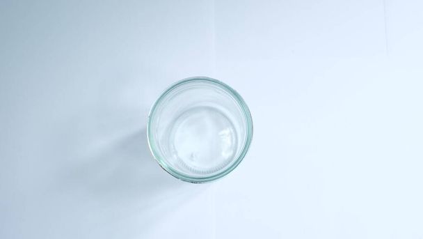 Empty clean drinking glass cup isolated on white background. - 写真・画像