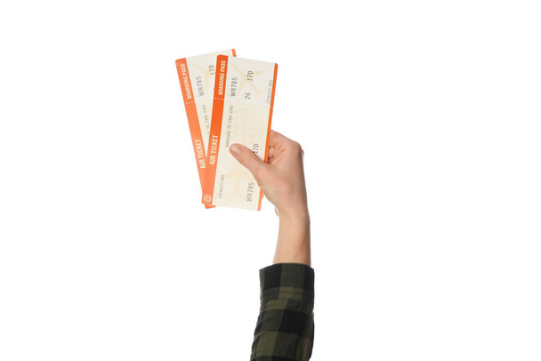 Air ticket in hand isolated on white background. Planning trip, summer vacation. - Foto, imagen