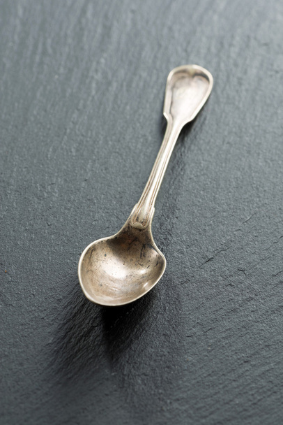 empty teaspoon on a dark background, concept photo - Fotografie, Obrázek