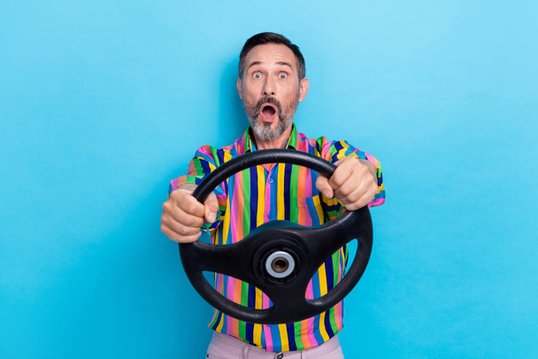 Photo of astonished afraid scared man stylish retro clothes impressed negative situation bad road speed isolated on blue color background. - Foto, afbeelding