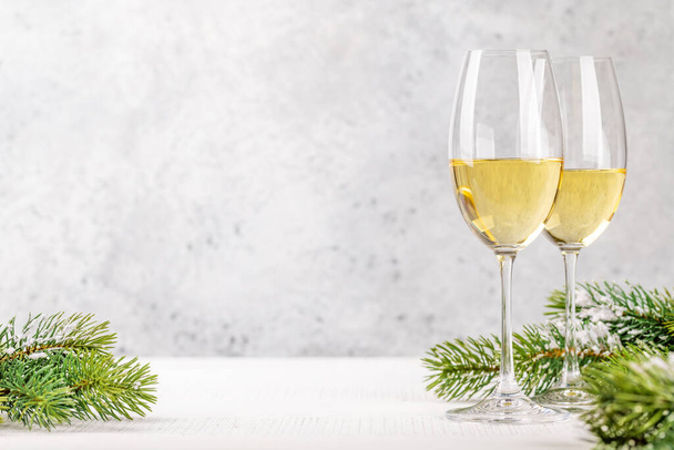 Christmas fir tree branches and champagne. With space for your Xmas greetings - 写真・画像