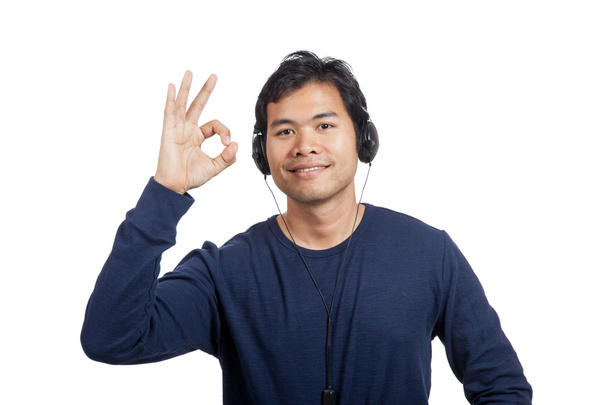 Asian man listen to music show OK sign - Foto, Bild