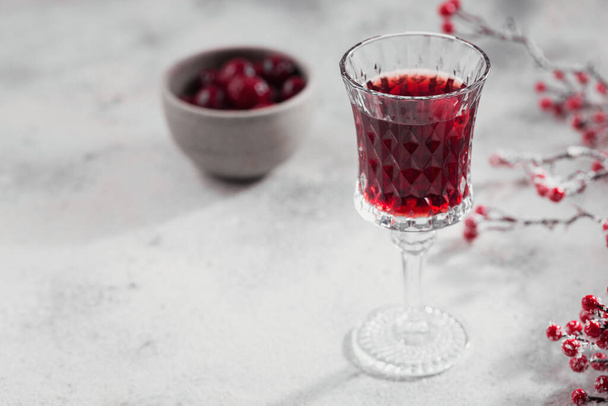 Homemade infused vodka, tincture or liqueur of red cherry on white background. Berry alcoholic drinks concept. - Fotografie, Obrázek