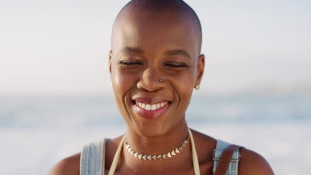 Black woman, bald or laughing face by beach, ocean or sea in Jamaican travel vacation, holiday vacation or summer break. Zoom, portrait or happy smile tourist, fashion person in relax nature location. - Footage, Video