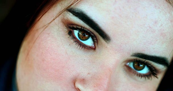 Young woman eyes staring at camera, macro close-up face - Photo, Image