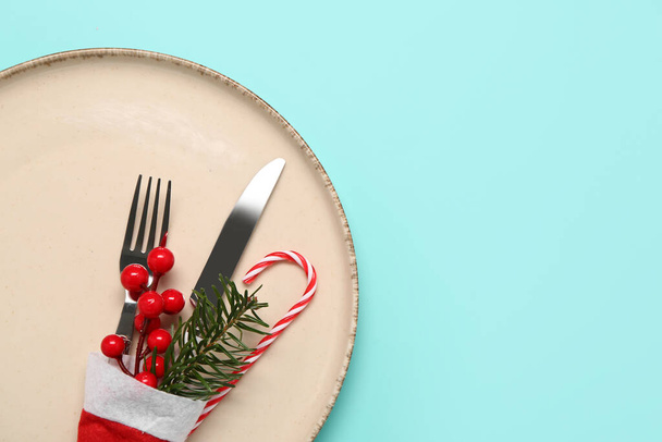 Table setting with Christmas decor and Santa hat on color background, closeup - Fotoğraf, Görsel