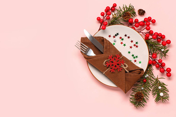 Table setting with Christmas branches and cranberry on pink background - Photo, Image