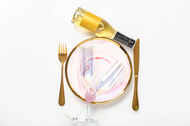 Table setting for Valentine's Day with bottle of champagne on white background - Photo, Image