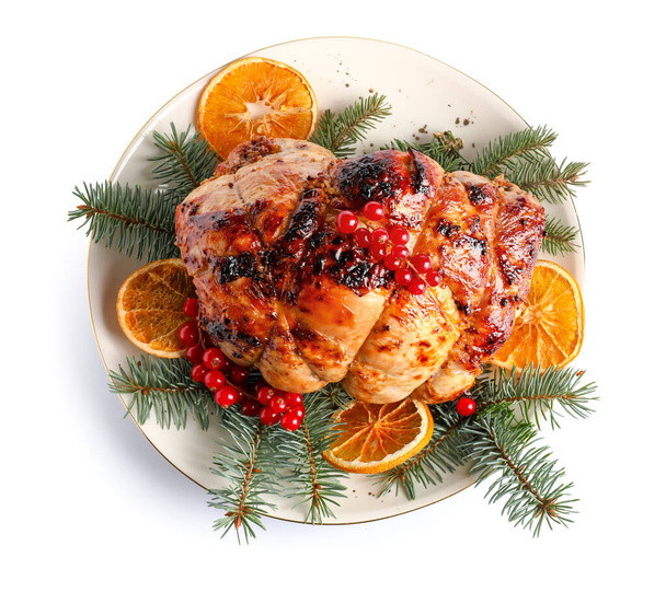 Plate with tasty Christmas ham, fir branches and dried citruses on white background - Foto, imagen