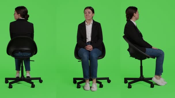 Kaukasische Geschäftsfrau im Anzug und auf einem Stuhl sitzend, wartend in Vorbereitung über Ganzkörper-Green-Screen-Kulisse. Junge Erwachsene, die als Angestellte in Unternehmen arbeiten, zeigen sich im Studio positiv. - Filmmaterial, Video