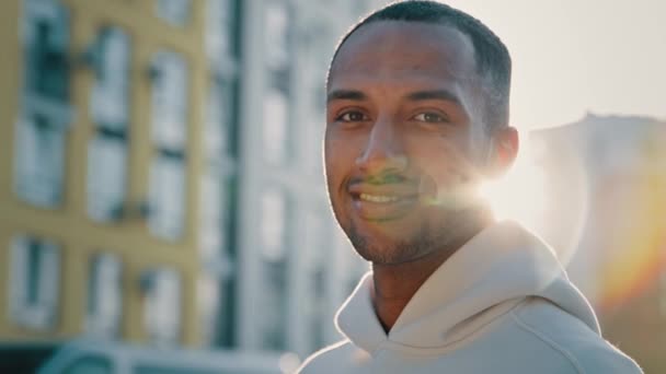 close-up man portret jong atletisch man knap Afrikaans amerikaanse latino guy staan in de stad alleen succesvolle millennial sportman student freelancer kijken naar camera glimlachen genieten van een gezonde levensstijl - Video