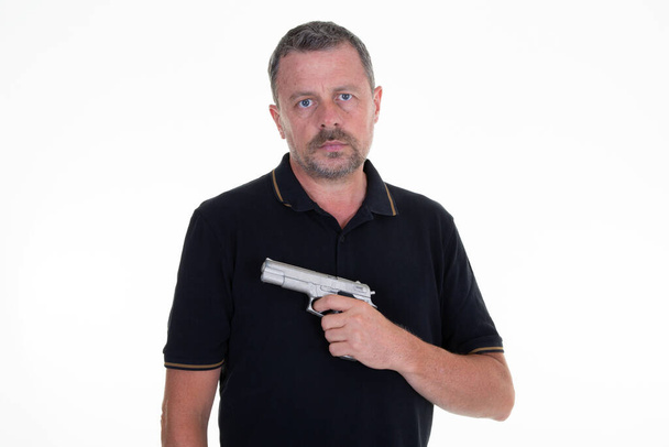 Caucasian male holding a gun on white background - Photo, Image