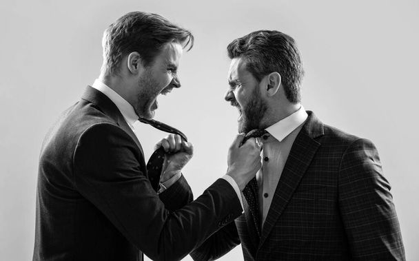 two colleagues have disagreement and conflict. businessmen face to face. disrespect and contradiction. business partners blame each other. arguing businesspeople. dissatisfied men discuss failure. - Valokuva, kuva