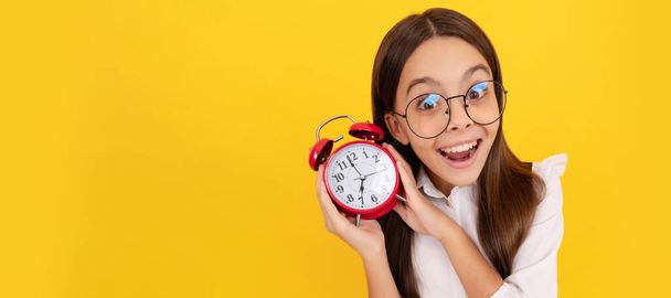 punctuality. last chance. punctual teen girl checking time. amazed nerd child listen the alarm. Teenager child with clock alarm, horizontal poster. Banner header, copy space - Photo, Image