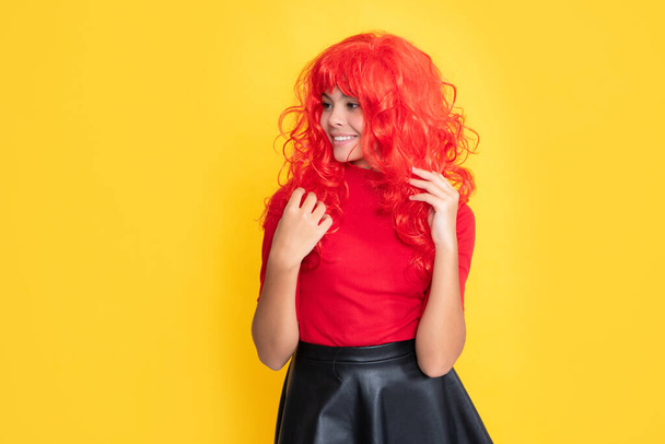 smiling teen child with red long hair on yellow background. - Foto, immagini
