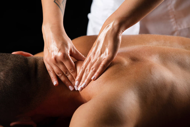 Massage for man. Physiotherapist massaging male shoulder - Zdjęcie, obraz