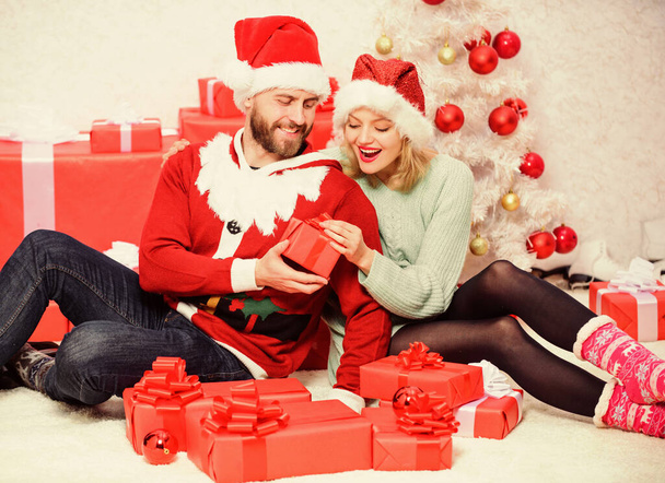 Family prepared christmas gifts. Loving couple cuddle smiling while unpacking gift christmas tree background. Couple in love happy enjoy christmas holiday celebration with gifts. Gift to beloved. - Fotoğraf, Görsel