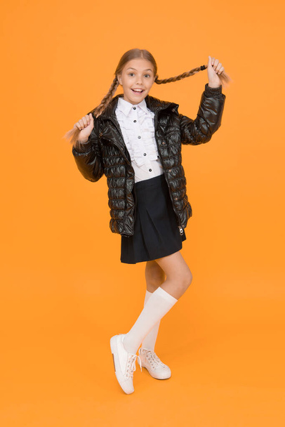 Warm clothing. Fall autumn winter. Fancy little child. Fashion shop. Cute girl wear black jacket on yellow background. Fashion concept. Buy clothes for school season. Schoolgirl fashion outfit. - Photo, Image