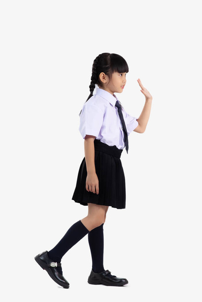 Asian student international school in uniform standing full length waving hand on white background. - Φωτογραφία, εικόνα