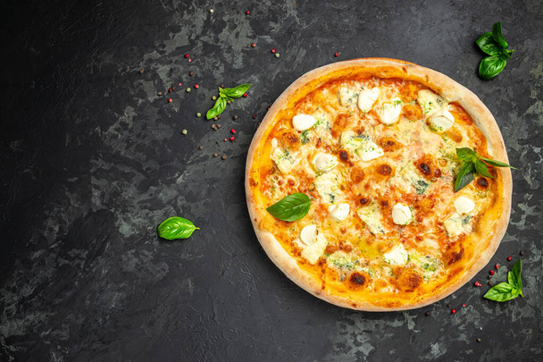 čtyři sýrové pizzy, domácí italská pizza. Pizza na rustikálním černém pozadí. Tradiční italská kuchyně. místo pro text, horní pohled. - Fotografie, Obrázek
