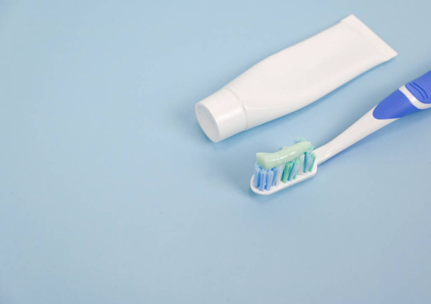 Toothpaste, toothbrush with toothpaste on blue background, health care lifestyle, oral dental care product, copy space - Photo, Image