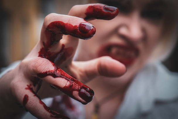 Close-up of messy bloody hand thats belongs to a vampire  - Foto, Imagem