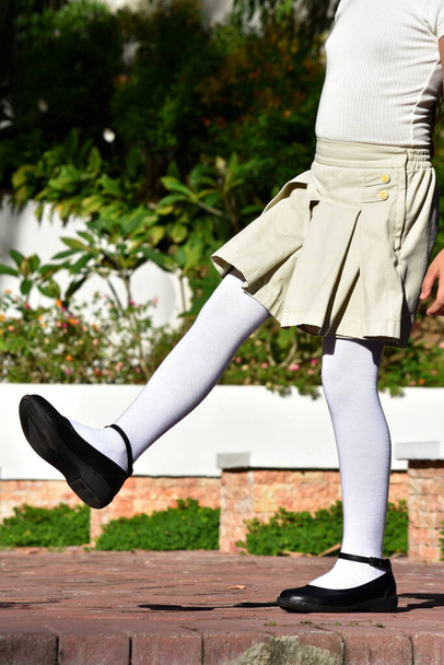 Female Child Wearing Skirt And White Socks - Фото, зображення