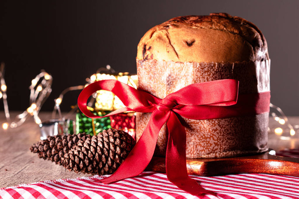 Fruit and Chocolate Chips Cake Served on a Wood Table decorated for Christmas. Homemade Christmas Even Bread on Blurry Background, Copy Space. - 写真・画像