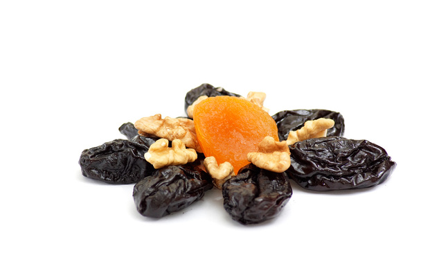 Dried apricot,walnuts and prunes on a white. - Фото, зображення