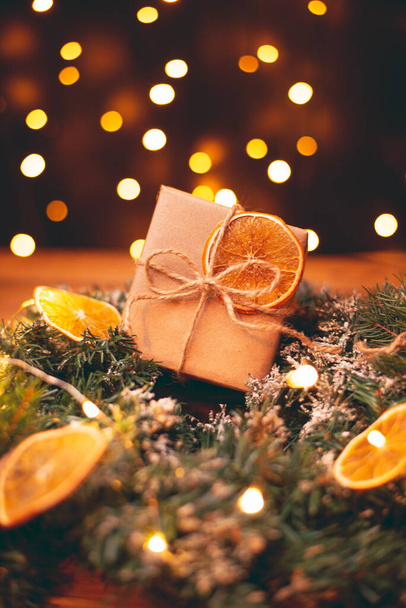 Christmas gift box wrapped in kraft paper with dried orange. - Foto, Imagen