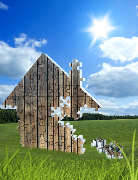 Casa que consta de puzzles en el prado
 - Foto, imagen