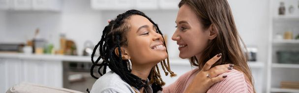 happy african american lesbian woman with with engagement ring hugging smiling girlfriend, banner - Φωτογραφία, εικόνα