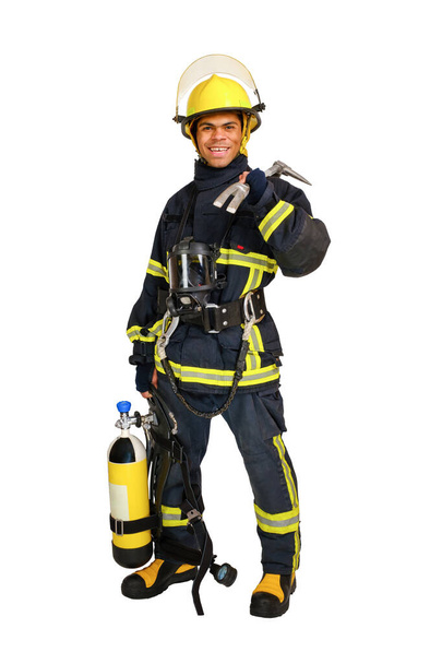 Full body young smiling African-American man in uniform of fireman with breathing air cylinder apparatus and full facepiece respirator and hooligan crowbar in hand, isolated on white background - Foto, imagen
