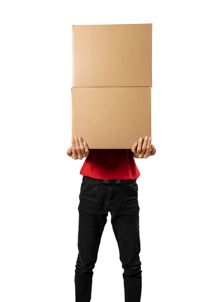 Parcel delivery man with a hat carrying a package isolated over white background - Photo, image