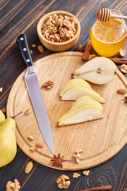 Ripe organic pear on the wooden cutting board Board at domestic kitchen. - Fotó, kép