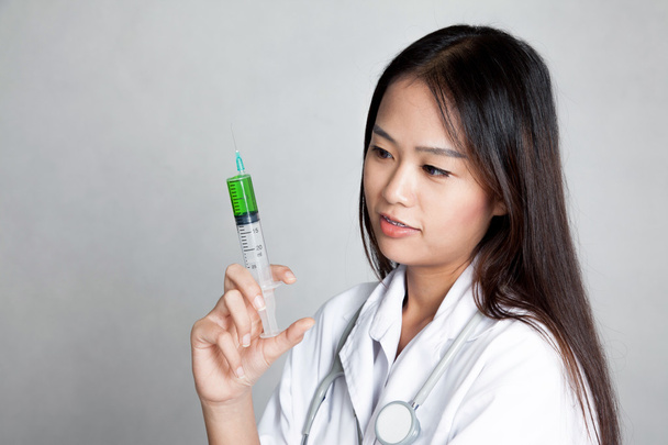Young Asian female doctor with syringe - Fotoğraf, Görsel